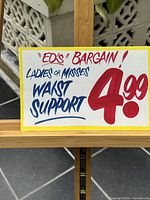 Front-facing view of the full sign mounted on wooden easel