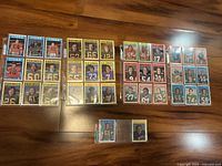 Front view of multiple 1972 OPC CFL Football Trading Cards from Lions, Eskimos, and Tiger-Cats, arranged in rows and protected by sleeves.