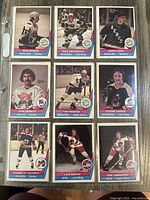 First photo shows nine hockey trading cards from 1977 featuring players from Whalers, Bulls, Stingers, Racers, Jets teams.