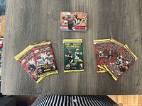 Collection displayed including 7 sealed yellow/red foil packs and 19 opened cards including player images with CFL Atomic branding.
