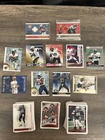 Top-down view showing a selection of eleven CFL Pacific trading cards including two game-worn jersey cards featuring players Joe Fleming and Ben Cahoon. Cards display player photos, team logos, and numbered editions.