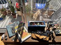 Overview of Star Trek items on table including bobbleheads, books, shirt, pins, and badges