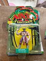 Elite Guard action figure from 2003 TMNT series, mint on card, includes multiple weapons, original packaging with minor shelf wear
