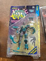 Total Chaos Timeslip female warrior action figure, factory-sealed with blue and silver colored armor and multiple clawed accessories in blister packaging.