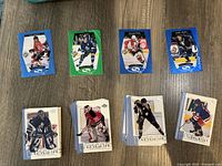 Top view of various Upper Deck hockey cards from 1998 and 2001 laid out on a table, showing front designs of the cards.
