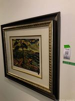 Framed Arthur Lismer print hanging on a wall with a wide, dark wood frame with gold inner edge and white mat board.