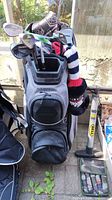 Overview of golf bag with clubs and headcovers