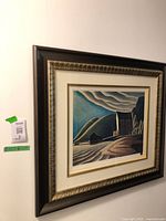 Framed print hanging on wall, full view