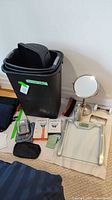 Full lot showing antique door knob, black plastic bins, Harry's razors, manual blood pressure meter, scale, mirror, and other items