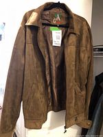 Front full view of the men's brown suede jacket hanging on a hanger, showing the front open with collar and zipper.