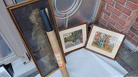 Photo showing two framed Group of Seven prints and two brass rubbing items, one framed and one unframed scroll.
