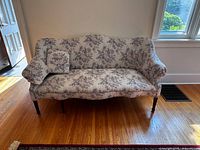 Full view of the late 1700s Georgian couch with floral upholstery, showing its overall shape and condition.