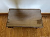 Top view of the rectangular wooden coffee table showing the glass surface and wood frame.