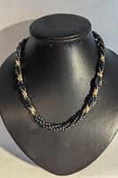 Full view of the vintage beaded necklace displayed on a black bust form