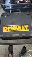 Closed Dewalt carrying case showing Dewalt logo in yellow on black plastic surface.