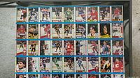 Photo showing first uncut sheet of hockey trading cards with multiple players in different team uniforms