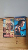 Two VHS tapes 'Joseph in Egypt' and '007 Never Say Never Again' in original cardboard sleeves