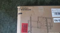 Box of the TV wall mount kit labeled Full-Motion TV Wall Mount PGF12