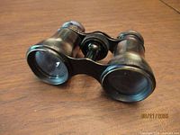 Opera glasses overall view showing lenses and mother of pearl panels