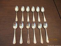 All 12 matching silver-plated teaspoons laid out