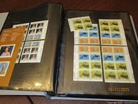 Open binder showing full panes and booklet of Canadian stamps