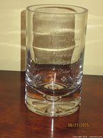 Full view of clear cylindrical crystal vase showing engraving and bubble base