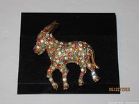 Front view gold-tone donkey rhinestone brooch on black card