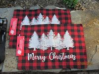Two new buffalo-plaid tapestry placemats with tags attached