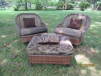 Two chairs and ottoman grouped on lawn