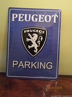 Front view of blue Peugeot parking sign