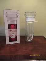 Box and glass wine preserver with stopper displayed