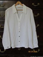 Front view white button-down blouse on hanger
