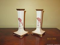 Front view of both porcelain candle holders showing flamingo motif and gold trim