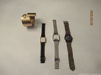 All four watches laid out showing types and relative size