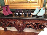All four pairs of footwear on table
