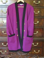 Front view of purple Chico’s coat hanging