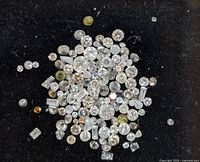 Top-down view of all loose diamonds on black background