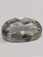 Top view of the oval green amethyst showing clear transparent facets and pale green color.