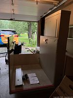 Lift platform in lowered position with mounting hardware and documentation on platform