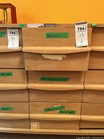 Wooden drawers with green labels indicating contents, part of lot.