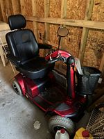 Full view of red Pride Mobility Celebrity XL scooter with black seat and headrest