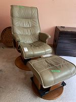 Front view of swivel chair and ottoman showing overall condition