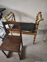 Antique wooden chair next to project bench with torn black vinyl seat