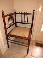 Front and side view of wooden corner chair showing turned spindle design and upholstered seat.