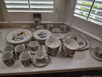 Full assortment of porcelain pieces laid out on counter