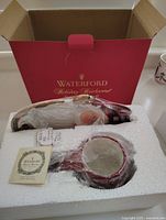 Original box with styrofoam insert holding Santa set securely in place.