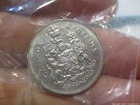 Reverse side of the 1969 Canadian 50 cent coin showing the Canadian coat of arms and denomination.