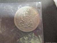 Reverse side of the 1975 Canadian 50 cent coin showing the Canadian coat of arms and the denomination 'CANADA 50 CENTS'.