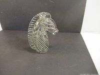 Front side view of clear art glass seahorse sculpture showing vertical air bubble lines and textured ridged crest along the head and neck.
