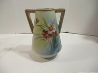 Front view of hand painted Nippon pottery vase showing floral design and double handles